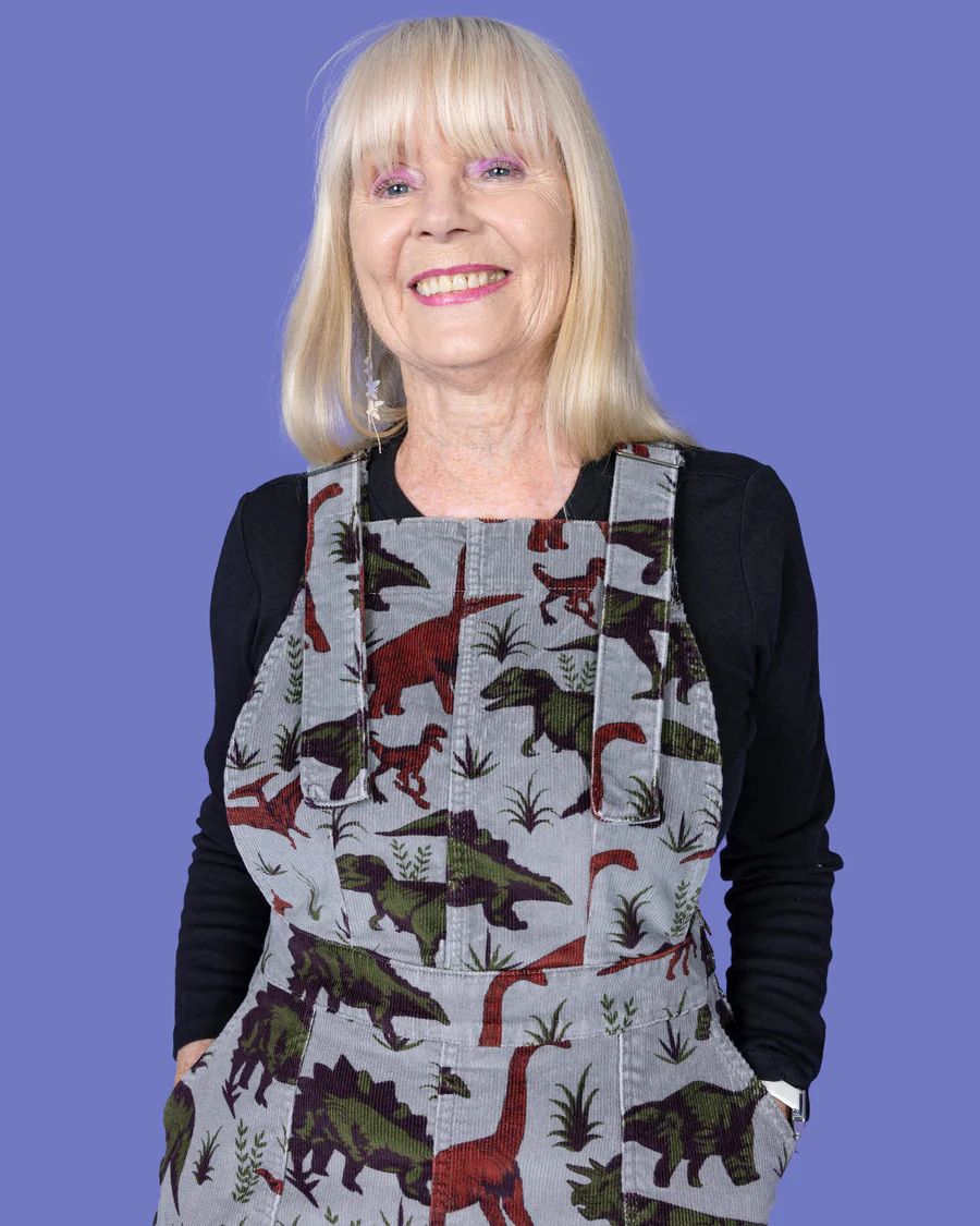 Portrait view of model wearing Run and Fly Dino Corduroy Pinafore.