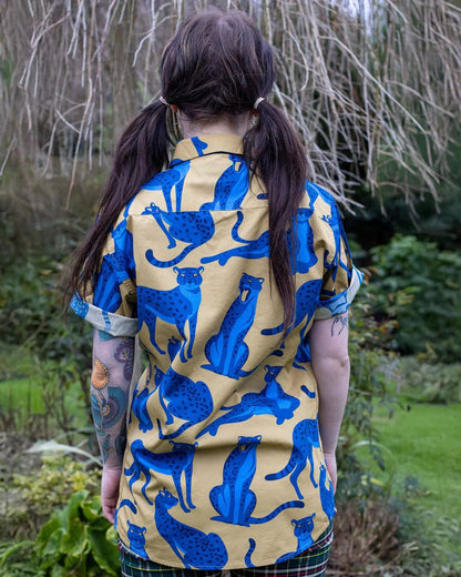 Back view of model wearing a Run and Fly Leopard Shirt
