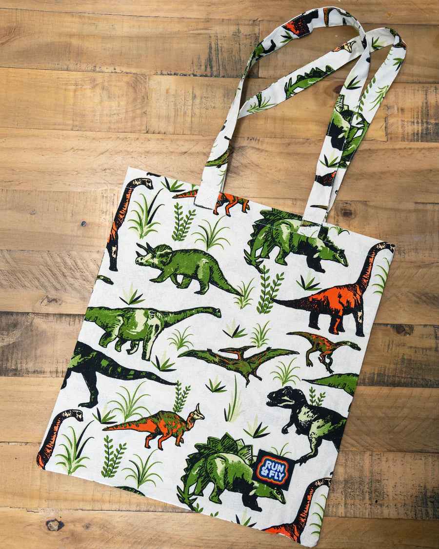 Flat lay of Run & Fly Natural Dino Tote Bag