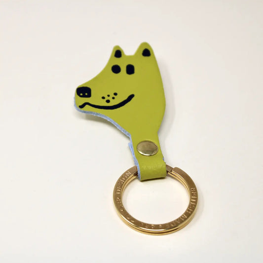 A green leather key fob in the shape of a dog's head with a gold plated ring.